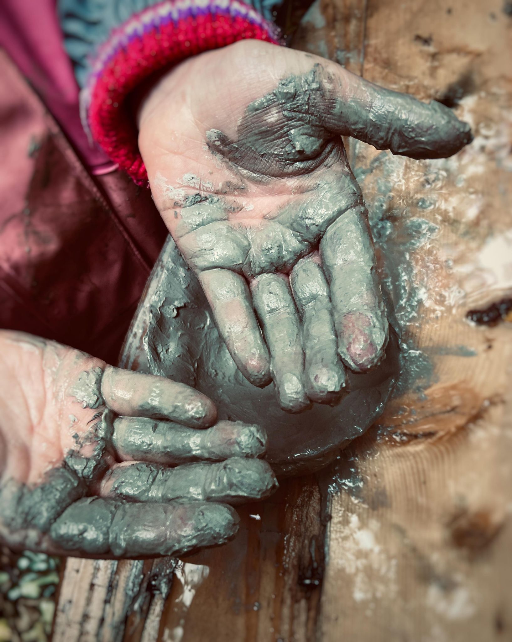Childs hands covered in mud at the steiner forest school and holiday camp in Bath UK