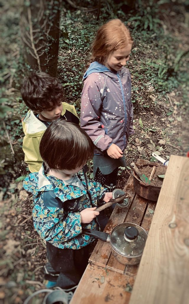children playing in the mud kitchen